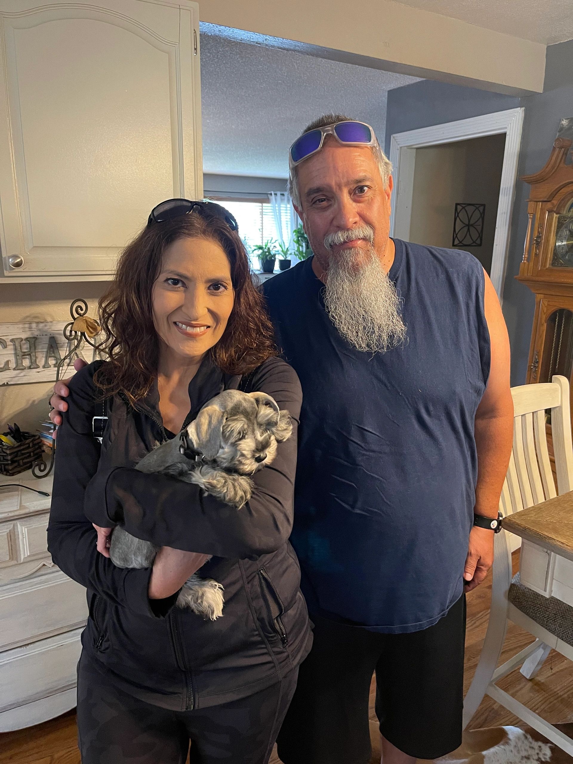 Couple welcoming their Miniature Schnauzer puppy