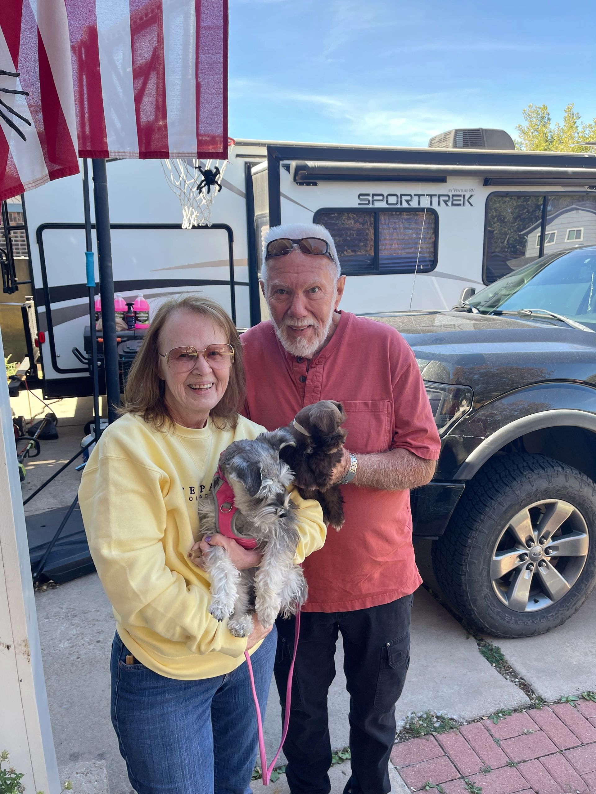 Couple taking their Miniature Schnauzer puppy home